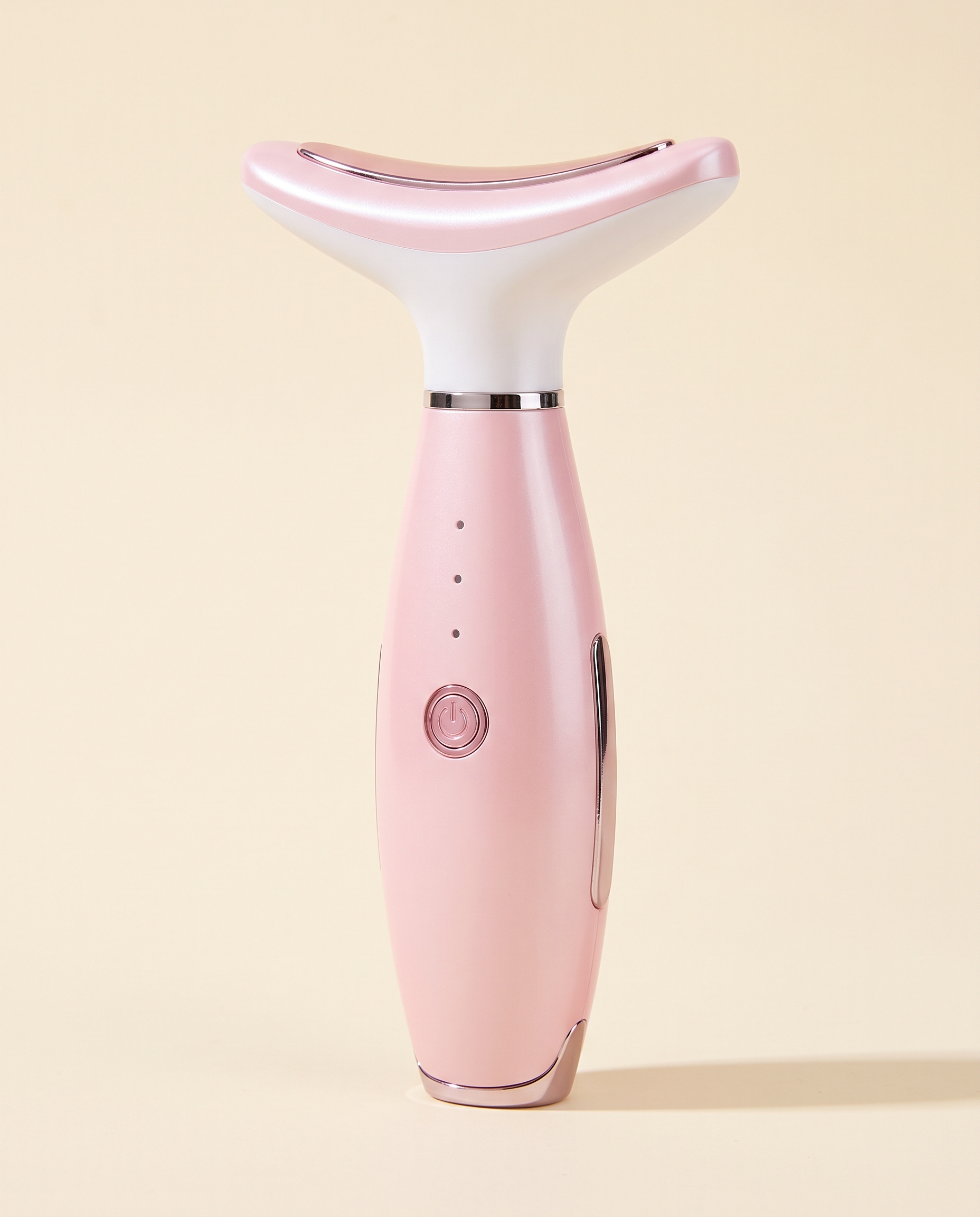 Pink handheld face and neck massager with three mode indicators